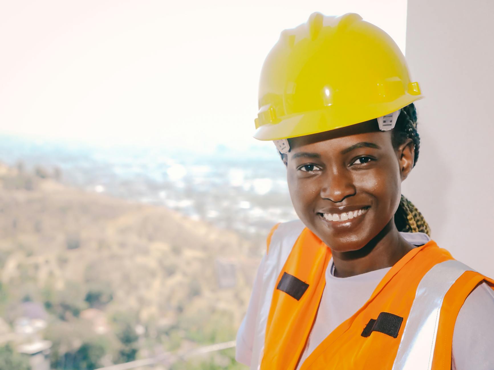 reflective vest and yellow hardhat worn by woman